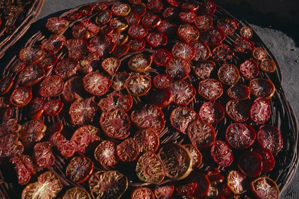 PAKISTAN, Hunza, Karimabad, "Sun dried tomatoes in large, shallow baskets."