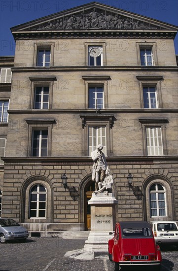 FRANCE, Il de France, Paris, Statue of Valentin Hauy outside the Institute for the Blind building.