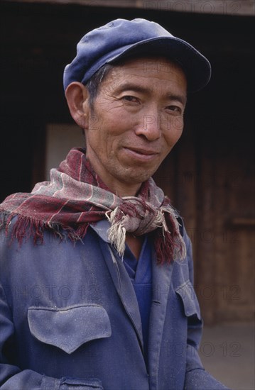 CHINA, Yunnan, Baisha, Portrait of a Naxi man wearing a cap and scarf