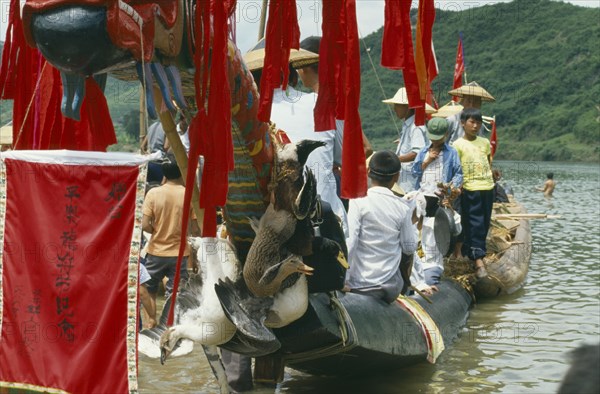CHINA, Guizhou Province, Celebrations, Dragon Boat festival. View along decorated boat with live geese tied to prow.