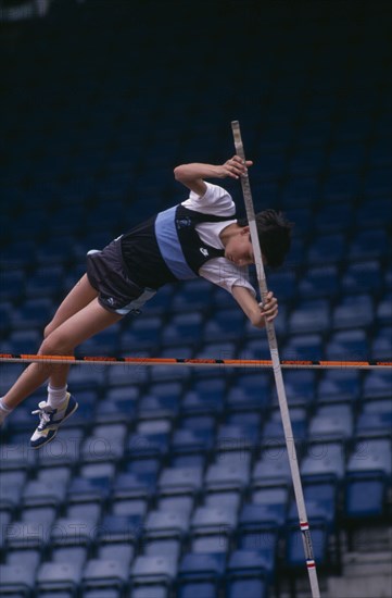 10037064 SPORT Athletics  Pole Vault Competitor in junior athletics championship at Crystal Palace clearing bar in pole vault.