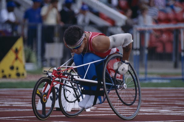 10037083 SPORT Athletics Track Disabled athlete lining up the front wheel of his wheelchair on the racing track.