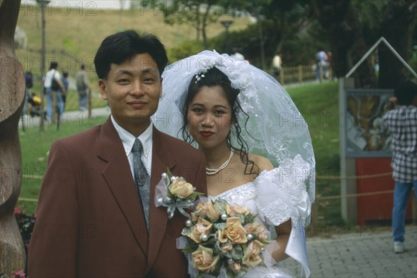HONG KONG, Central, Hong Kong Park, "Fashionable western style wedding.  Bride and groom, head and shoulders portrait."