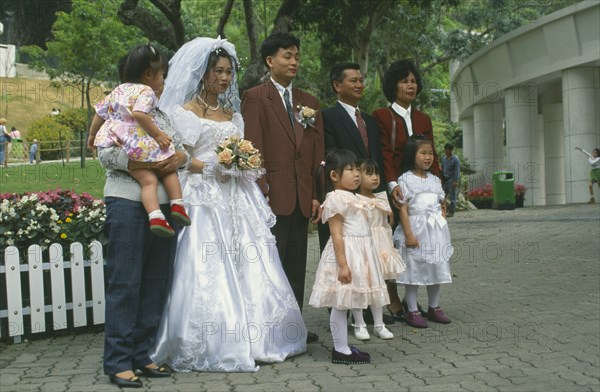 HONG KONG, Central, Hong Kong Park, "Western style wedding, bride, groom, bridesmaids and family posing for photograph."