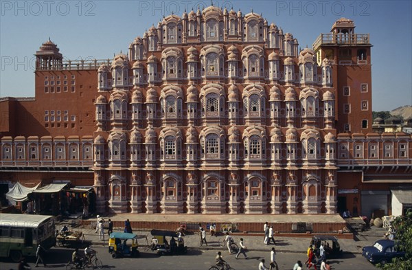 INDIA, Rajasthan, Jaipur, "Hawa Mahal or Palace of the Winds facade dating from 1799.  Busy street in foreground, bus, motor-rickshaws and people."