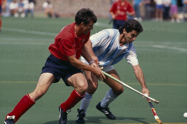 10037385 SPORT Ball Games Hockey Two players from each team during a match between England and Argentina at Bisham Abbey