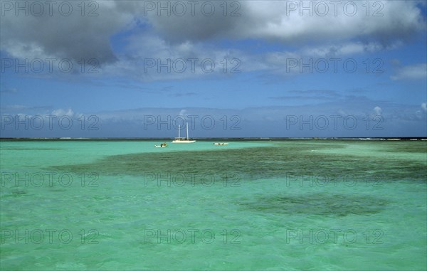 WEST INDIES, Tobago, Buccoo Reef, The Nylon Pool with yacht anchored on the horizon