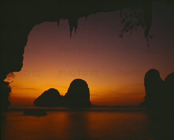 THAILAND, South, Krabi, "Phra Nang beach, orange sunset behind rock formations in the sea "