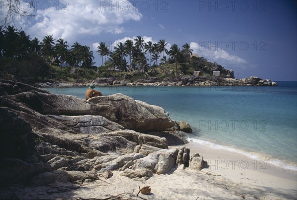 THAILAND, Koh Pha-Ngan Island, Coral Bay, View from beach over rocks toward bay surrounded by rocks and palms