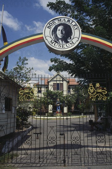 WEST INDIES, Jamaica , Kingston, Bob Marley Museum entrance with metal gate under archway.