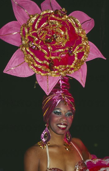 CUBA, Havana Province, Havana, Tropicana Club female dancer in pink costume with pink head-dress in the shape of a flower