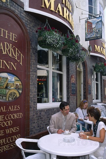 ENGLAND, East Sussex, Brighton, Couple outsdie the Cricketers Pub.