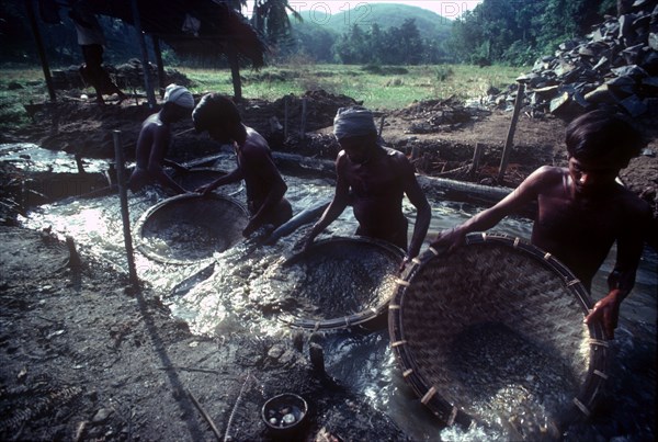 SRI LANKA, Ratnapura, Men panning for gems in a gem mine