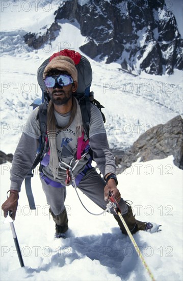10029912 SPORT Climbing Mountaineering Pakistan.  Porter climbing to camp 1 on K2.