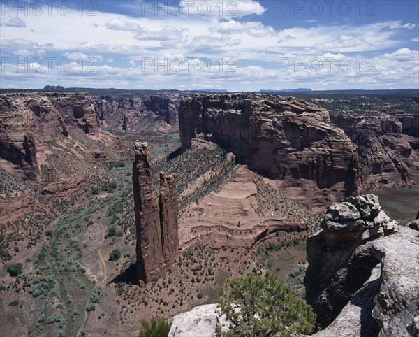 USA, Arizona, Canyon de Chelly, View looking down to Spider Rock with canyon beyond and scree slopes. A path cuts through canyon floor.