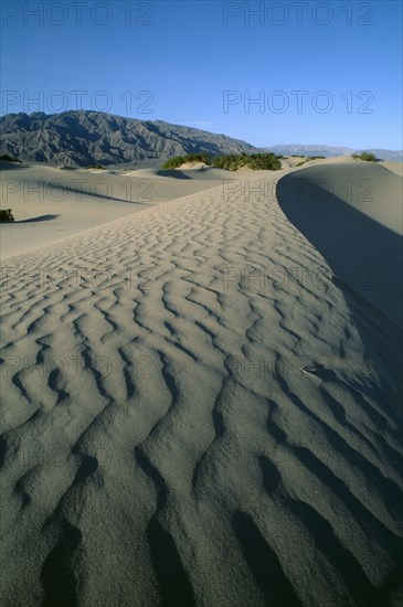 USA, California, Death Valley, Desert landscape leading to rocky hills