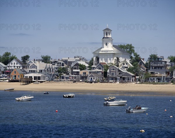 USA, Massachusetts, Cape Cod, Provincetown. The beach with houses along the sand and small boats at anchor