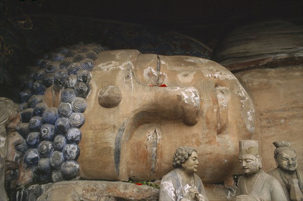 CHINA, Sichuan, Baoding, Tang Dynasty reclining sleeping Buddha depicting the state of achieving nirvana carved into the cliff at Dazu