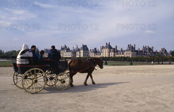 FRANCE, Fontainebleau, Tourist horse and cart travelling through grounds