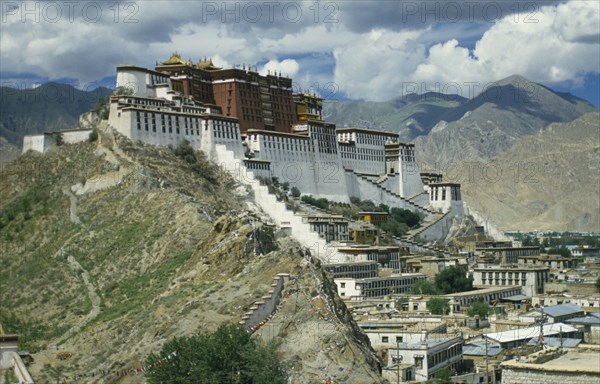 TIBET, Lhasa, Potala Palace, Near view of buildings set on hill in valley surrounded by mountains