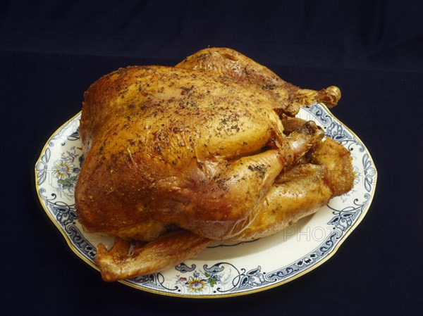 FOOD, Meat, Cooked, Roast Turkey and mixed herbs on a plate.