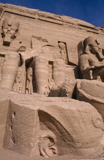 EGYPT, Abu Simbel, Three of the four giant statues of Ramesses II at the entrance of the Great Temple