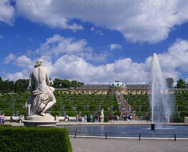 GERMANY, Brandenberg, Potsdam, "Sanssouci Park, terraced steps and topiary leading to the Palace with fountain and statues in the foreground."