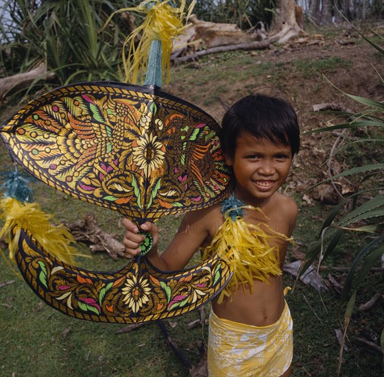 MALAYSIA, Kelantan, Kota Baharu, Malay boy holding multicoloured kite