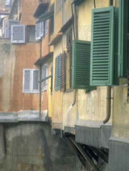 ITALY, Tuscany, Florence, Shutters on houses on  the Ponte Vecchio over the River Arno