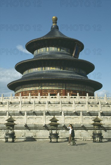 CHINA, Hebei, Beijing, Temple of HeavenRound temple standing on a square base with passing men