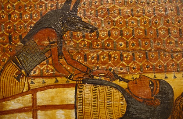 EGYPT, Cairo, Painting on wooden coffin. Jackal Headed God Anubis over reclining figure