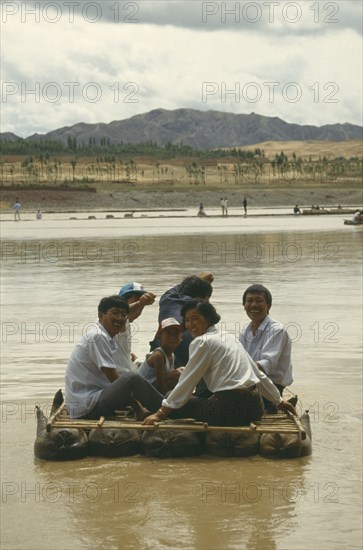 CHINA, Yellow River, People traveling down river on Hide Raft