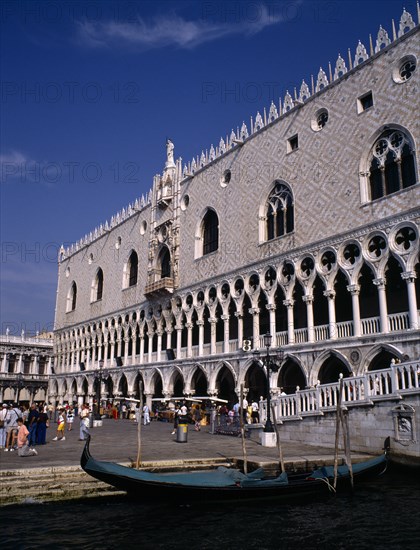 ITALY, Veneto, Venice, Doges Palace aka Palazzo Ducale exterior with moored gondola in the foreground