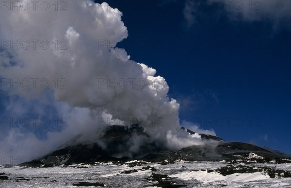 ITALY, Sicilly, Mount Etna, Smoke and ash rising from the snow covered volcano