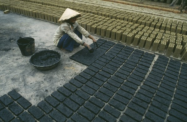 ARCHITECTURE, Vietnam, Hoi An, Brick production worker laying out newly made bricks