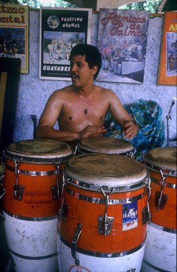 CUBA, Music, Drummer sitting behind large red and white drums