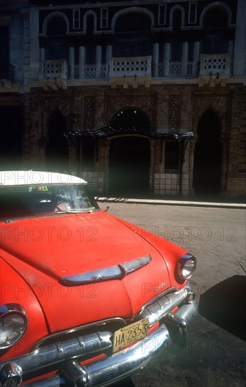 CUBA, Havana, Detail of red US style car parked on Old Havana street.