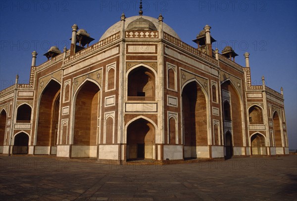 INDIA, Delhi, Tomb of the Emperor Humayun built in the 16th century in Mughal architectural style.  Red and white sandstone with black and yellow marble inlays.