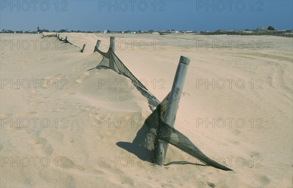 NAMIBIA, Swakopmund, Barrier to stop encroachment of sand dunes.