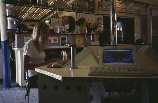 COMPUTERS , World Wide Web, Internet Cafe, AUSTRALIA Byron Bay. Internet cafe with girl at computer terminal.