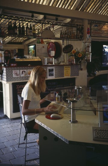 COMPUTERS , World Wide Web, Internet Cafe,  AUSTRALIA Byron Bay. Internet cafe with girl at computer terminal.