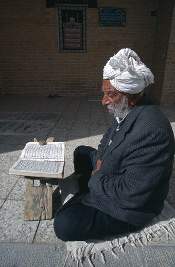 IRAN, , Yazd, Man reading Koran