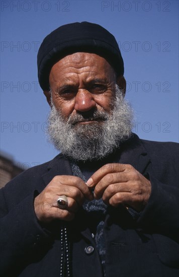 IRAN, Tabriz , Portrait of an elderly man dressed in black with prayer beads