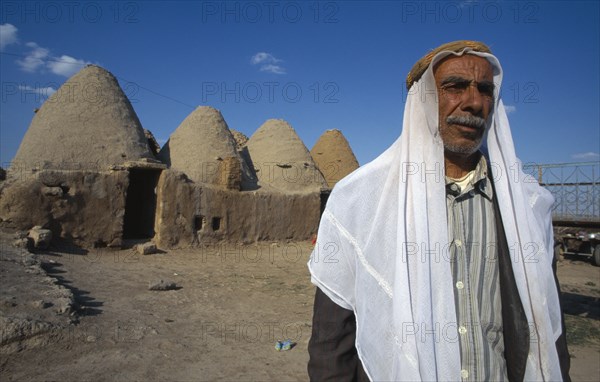 TURKEY,   , Harran, Old man stands outside beehive mud houses