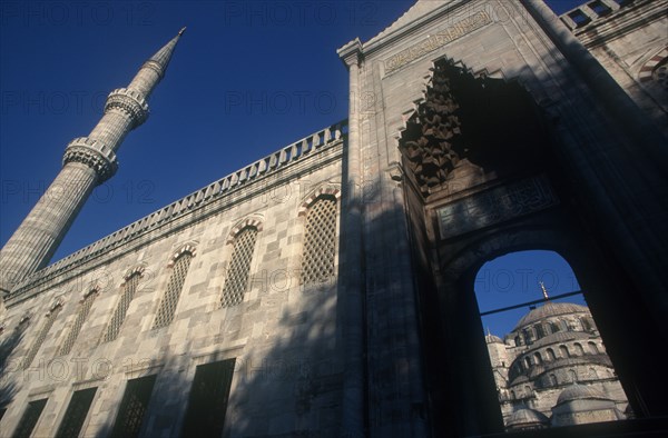 TURKEY, Istanbul  , Blue Mosque or Sultan Ahmet Cami mosque. Angled view looking up toward archway and tower