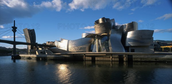 SPAIN, Basque Province, Bilbao, The Guggenheim Museum in evening light.