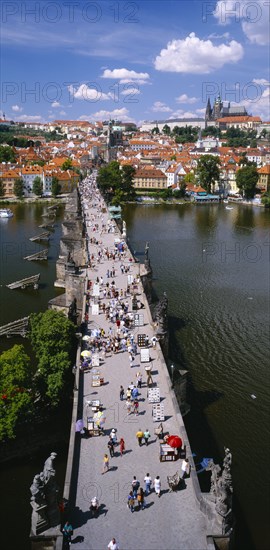 CZECH REPUBLIC, Stredocesky, Prague , Mala Strana.  Charles Bridge.  Aerial view along bridge busy  with tourists and traders selling souvenirs.