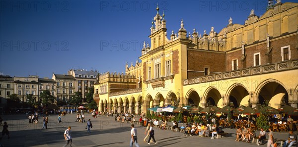 POLAND, Krakow, Rynek Glowny or Grand Square and the sixteenth century Renaissance Cloth Hall lined with busy cafes.