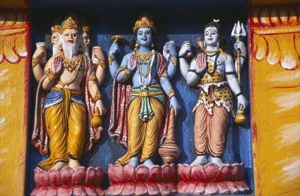 INDIA, Orissa, Gopalpur on Sea, Detail of brightly coloured temple statues of the Hindu Gods Vishnu and Siva