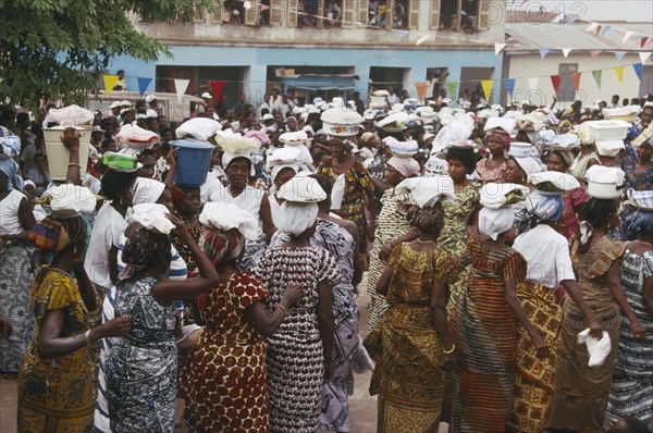 GHANA, Larteh, NOT IN LIBRARY Women carrying offerings on their heads at the Golden Jubilee celebrations